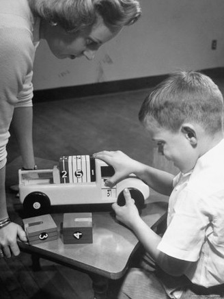 Scene from the Carnegie Inst. of Technology, with a Small Boy Playing with an Add and Load Toy
